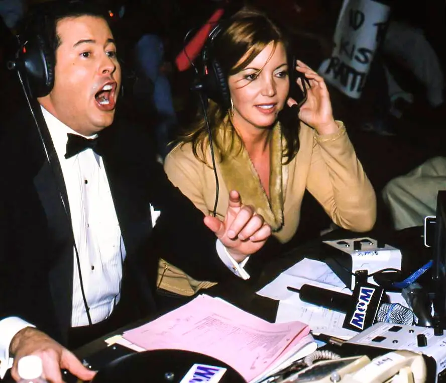 Ms. Buss, ringside at a taping of WOW with David McLane, who founded the league.Credit...WOW Television Enterprises, LLC