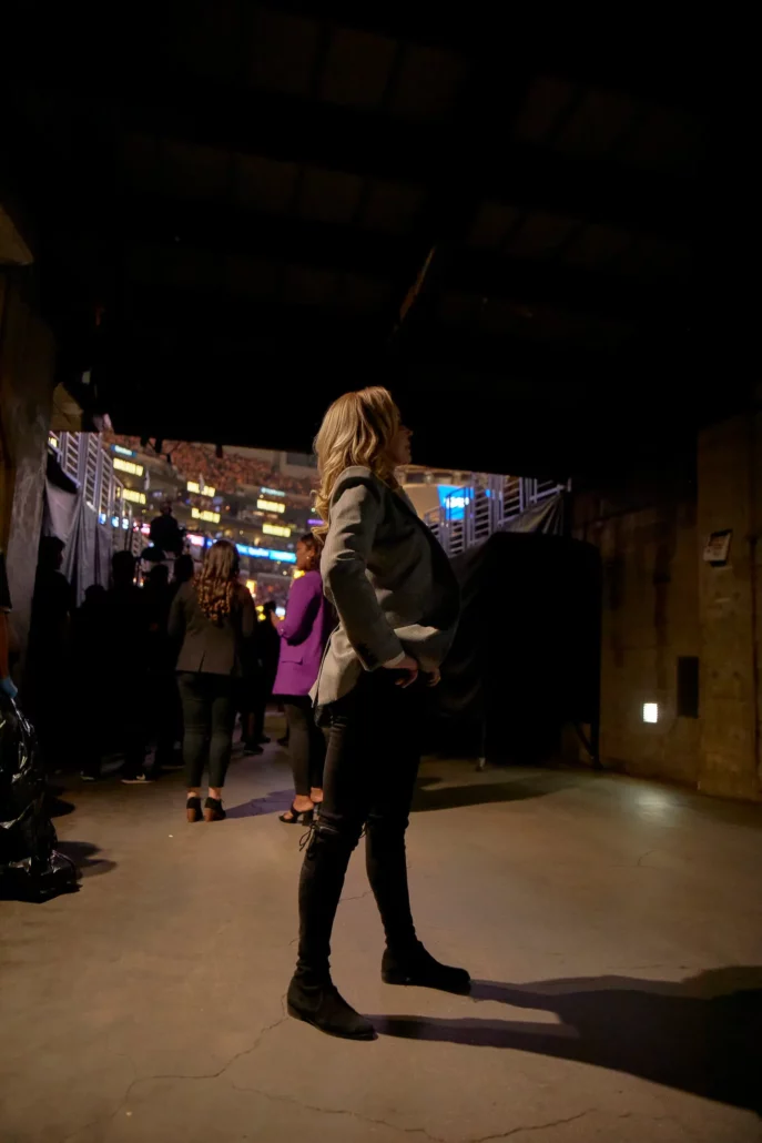 Ms. Buss standing in the bowels of the Los Angeles Lakers’ home arena. She grew up watching her father turn the team into a juggernaut, and she sees no reason the same can’t happen with WOW. Credit...Magdalena Wosinka