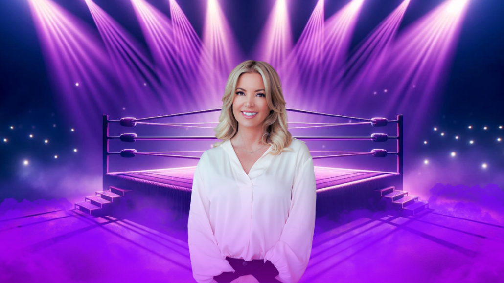 Jeanie Buss on front of wrestling ring